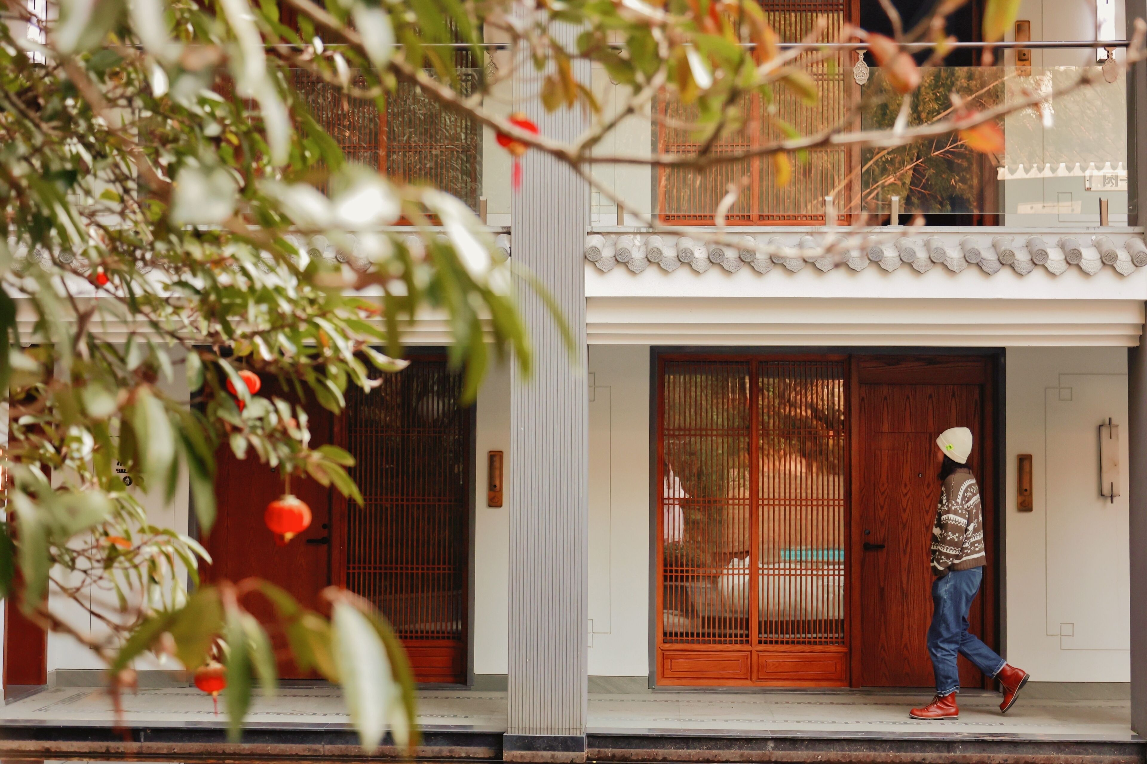 A traditional building with a wooden door and a balcony.