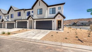 A modern two-story house with a garage, a driveway, and a landscaped front yard. - Skyline Resort, Private Hot tub, Resort amenities! (Washington)