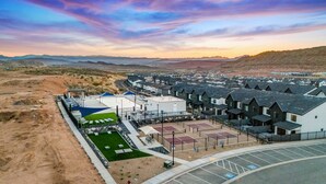 A residential area with houses, a parking lot, and a sports court. - Skyline Resort, Private Hot tub, Resort amenities! (Washington)