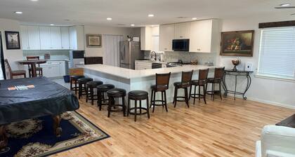 Stylish 2BR/2BA retreat w/ open layout, pool table & shared covered patio oasis.