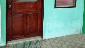 A wooden door with a window to the right.