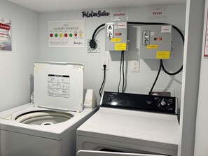 A laundry room with a washing machine, dryer, and a wall-mounted washer and dryer unit. - Parkview - A Cozy Gem (Mississauga)