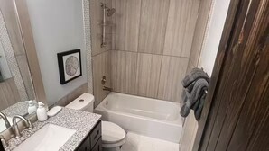A bathroom with a sink, toilet, and bathtub. - Entire home in Houston central, Texas (Houston)