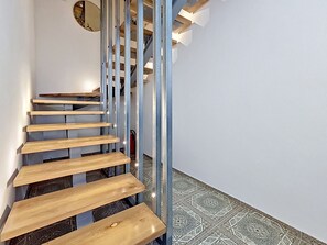 A spiral staircase with wooden steps and metal railings, leading to an upper floor. - Dalmatica by Interhome (Kaštela)