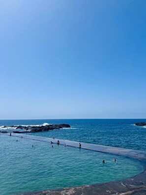 A coastal swimming area with clear blue water and rocky outcrops. - El Mirador-mesa del Mar (Tacoronte)