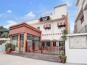 A hotel with a prominent sign, a gated entrance, and a small porch area with potted plants. - Saver Double Hotel Shivam Residency (Dehradun)