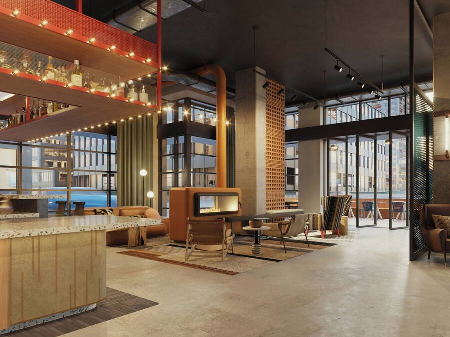A spacious lobby with a bar area, seating, and a fireplace.