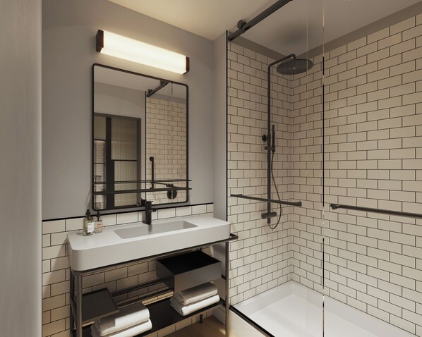 Een moderne badkamer met een wit wastafelmeubel, een spiegel en een douchegedeelte met een betegelde wand.
