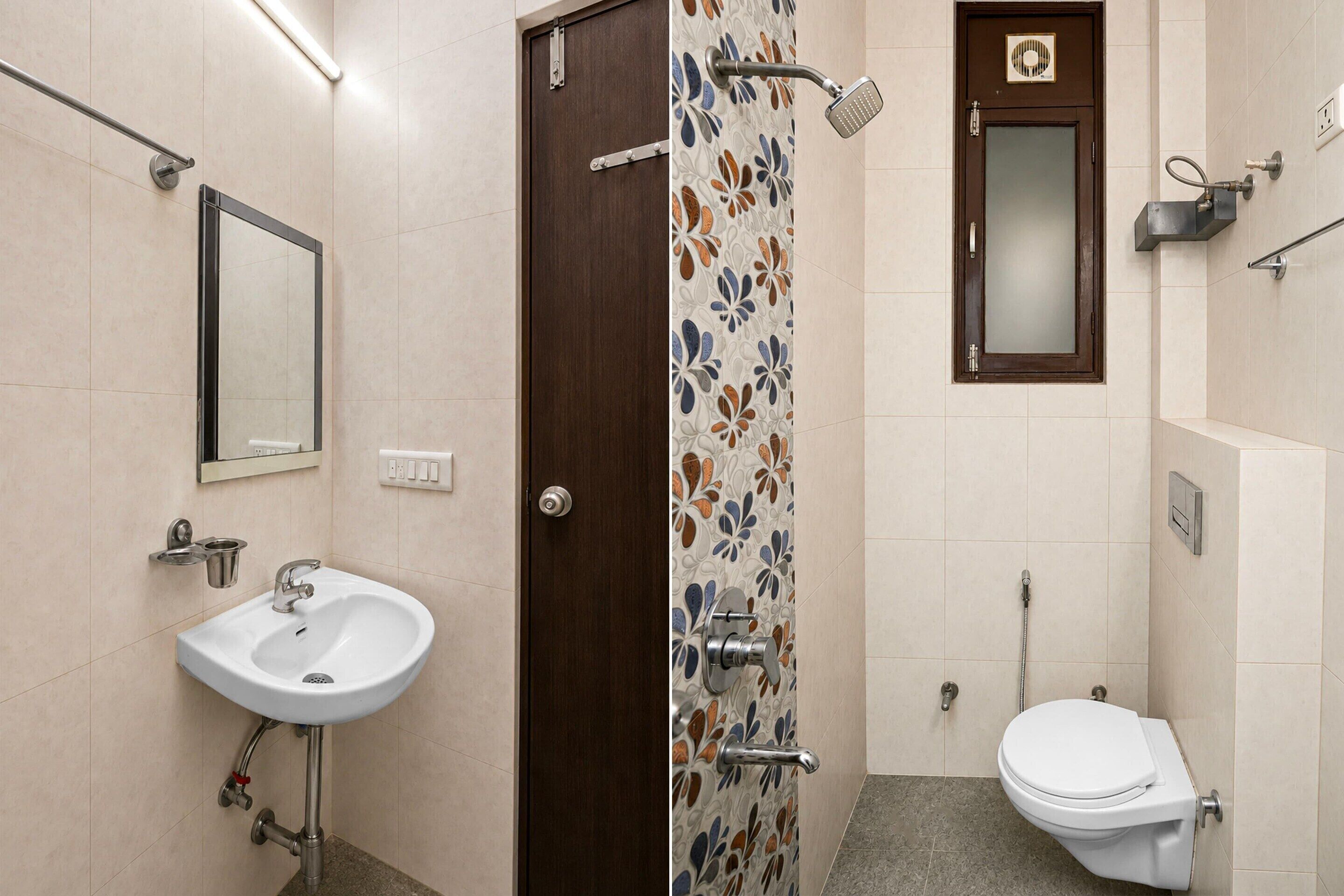 A bathroom with a white sink, a shower with a handheld showerhead, and a toilet.