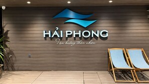 A wall with a logo and text reading 'HAIPHONG' and 'Tân khuông thên khiên'.