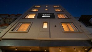 A multi-story building with a sign reading 'TOWNHOUSE' and 'Company Serviced.' - Suite Hotel Midway (Amritsar)