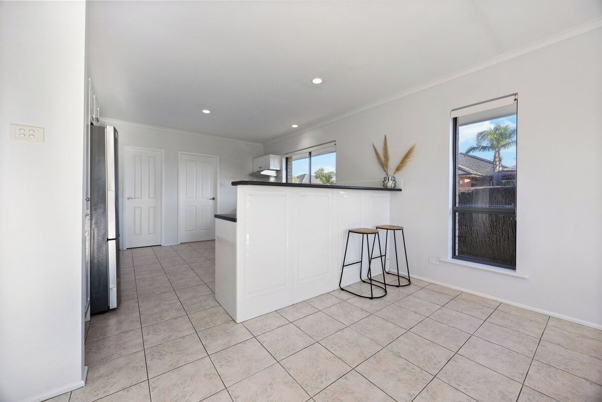 The open kitchen layout includes casual breakfast seating and plenty of space to gather while cooking and entertaining.