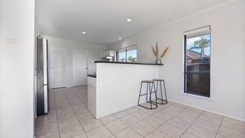 The open kitchen layout includes casual breakfast seating and plenty of space to gather while cooking and entertaining.
