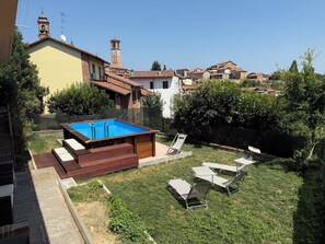 A residential property with a swimming pool, outdoor seating, and a view of neighboring houses. - Il Borghetto di Castagnole by Interhome (Castagnole Monferrato)