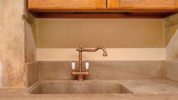 A bathroom with a wooden cabinet above a sink.