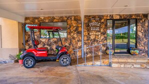 A building entrance with a stone facade, a red golf cart, and a sign that reads 'GIFT SHOPPE SAGE OFFICE.' - Accessible|2 Queen Beds|Nsmk (Snyder TX)