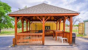 A wooden gazebo with a roof, a table, and benches. - Accessible|2 Queen Beds|Nsmk (Snyder TX)