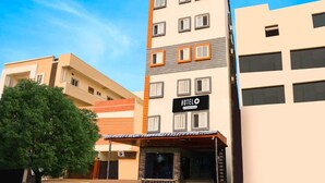A multi-story hotel building with a sign reading 'HOTEL O & Company Service.' - Super Hotel O Gachibowli Near ISB (Hyderabad)