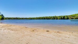 A sandy beach with a calm lake and a forested hill in the background. - Game Room, Deck & Fire Pit! Pocono Mtn House (Blakeslee)