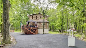A lodge with a wooden exterior, a covered deck, and a small staircase leading to the entrance. - Game Room, Deck & Fire Pit! Pocono Mtn House (Blakeslee)