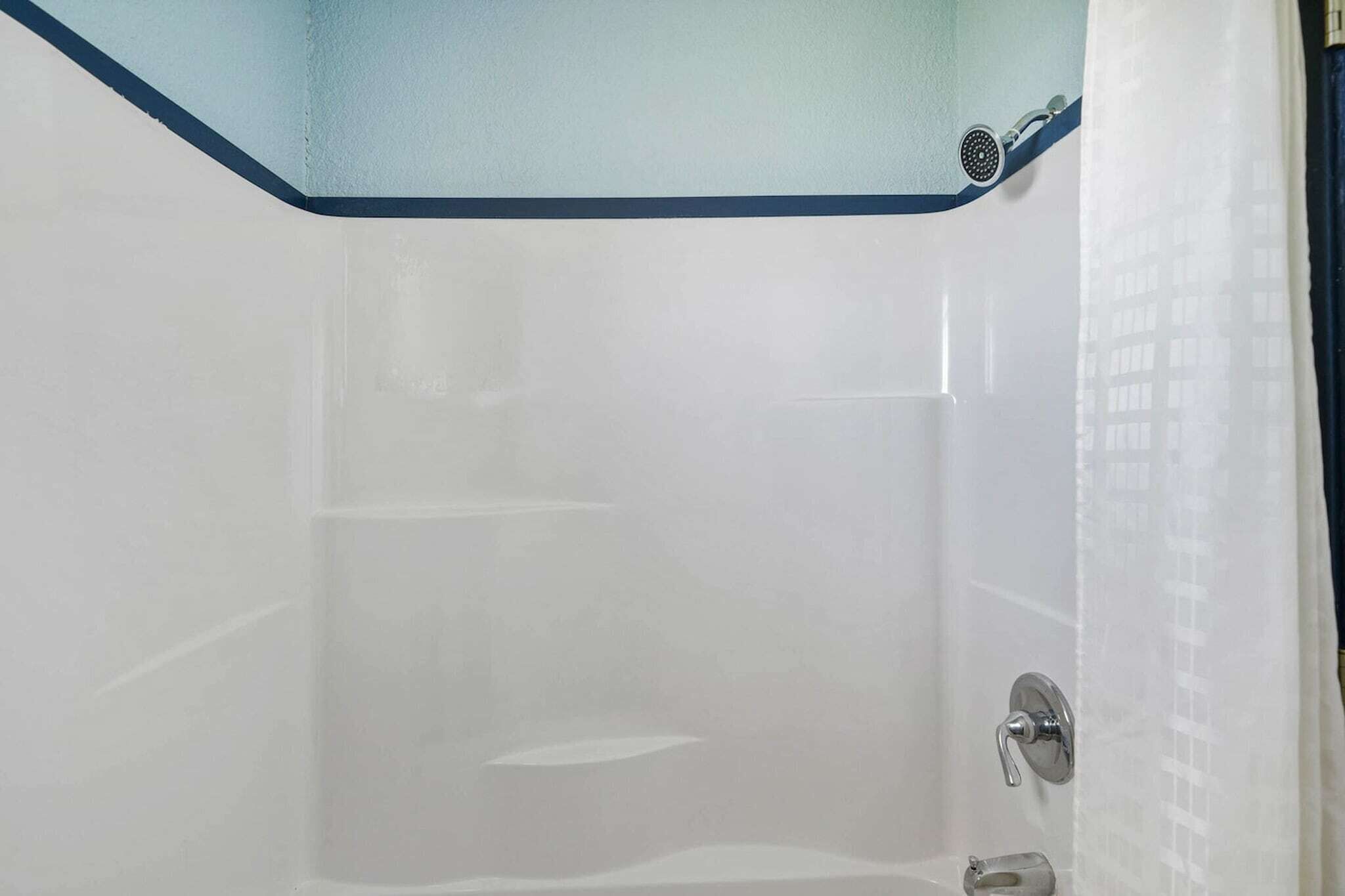 A bathroom with a bathtub, a shower, and a toilet.