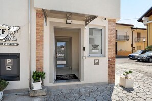 A building with a sign indicating a luxury suite, a door with a window, and a parking sign.