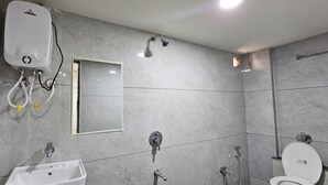 A bathroom with a shower, sink, and toilet.