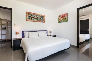 A modern hotel room with a large bed, two bedside tables, and two wall-mounted paintings. - Villa Ocean's Height By Fays Hospitality (Bali)