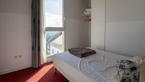 A hotel room with a bed, a window with curtains, a view of a bridge, and a wardrobe. - Classic Riviera Escape with Pool, Grasse (Grasse)