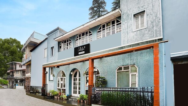A two-story building with a sign reading 'Collection.' - Super Collection O Mall Road (Dehradun)