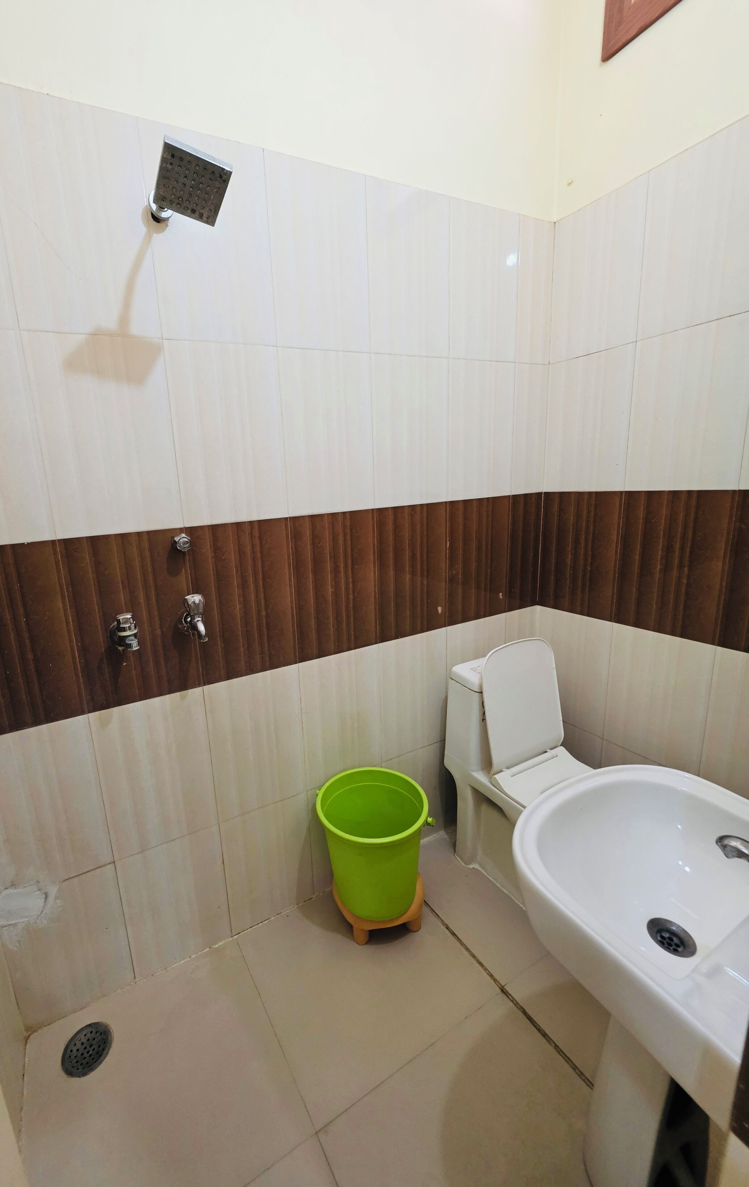 A bathroom with a shower, toilet, and sink.