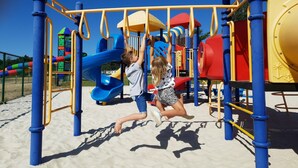 A playground with a blue slide and monkey bars. - Cozy Coco Sweet Glamping Tent for 4 (Rijkevorsel)