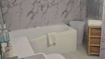 Combined shower/bathtub, deep-soaking bathtub, towels