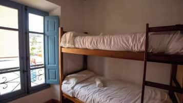 A bunk bed room with a window and a balcony.