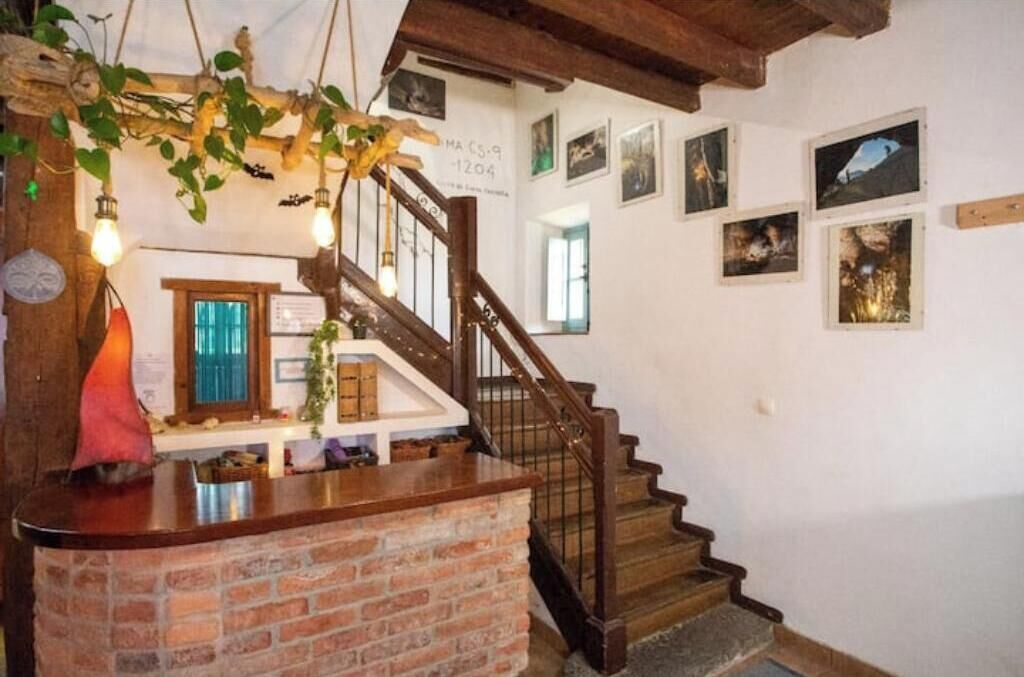 Una escalera con barandillas de madera y un muro de ladrillo.