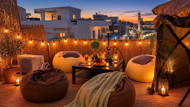 A rooftop terrace with bean bags, a table with drinks, and string lights. - Elegant 2 Bedroom Apartment with Rooftop Terrace (Lemesos)