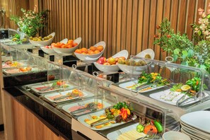 A buffet with various food items and a wooden wall in the background. - Ayramin Deluxe Hotel Anex (İstanbul)
