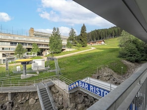 A view of a building with a sign reading 'BAR RISTO' and a staircase leading to a platform. - Alpen Nook - Sci e Natura by Interhome (Marilleva 1400)
