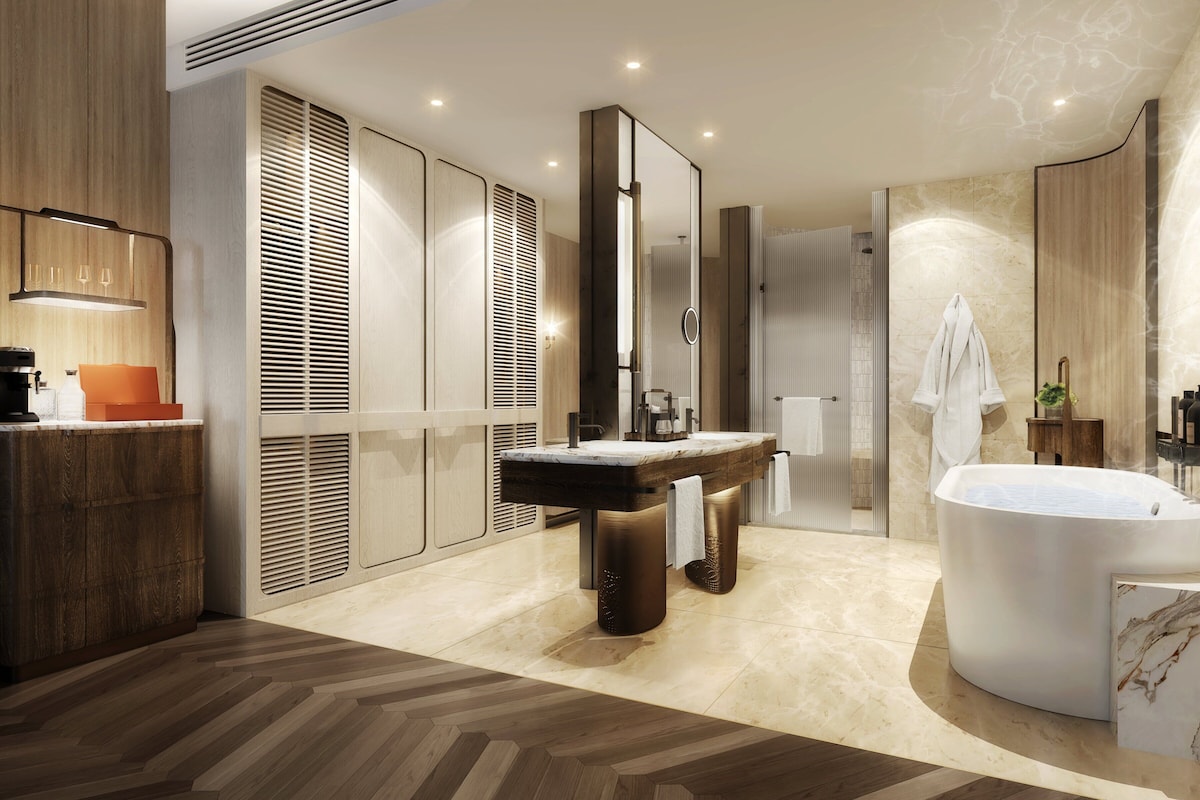 A modern bathroom with a freestanding bathtub, a vanity with a mirror, and a shower area.