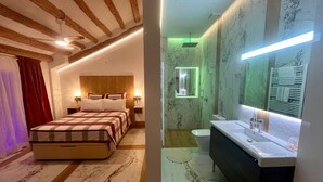 A bedroom with a bed, bedside tables, and a ceiling fan.