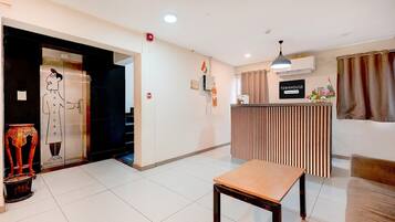 A reception area with a reception desk, a bench, a door with a cartoon character, and a sign that reads 'TOWNHOUSE.'