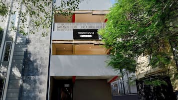 A modern building with a sign reading 'TOWNHOUSE Company Serviced.'