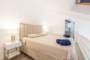 Ein Schlafzimmer mit einem Bett, Nachttischen und einem Beistelltisch.