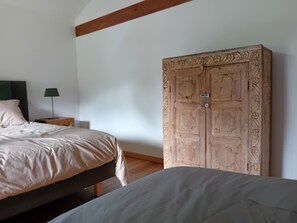 A bedroom with a bed, a nightstand, a lamp, and a large wardrobe. - Villa Nature Pool Air Cooler 12P (Sainte-Eulalie-en-Born)