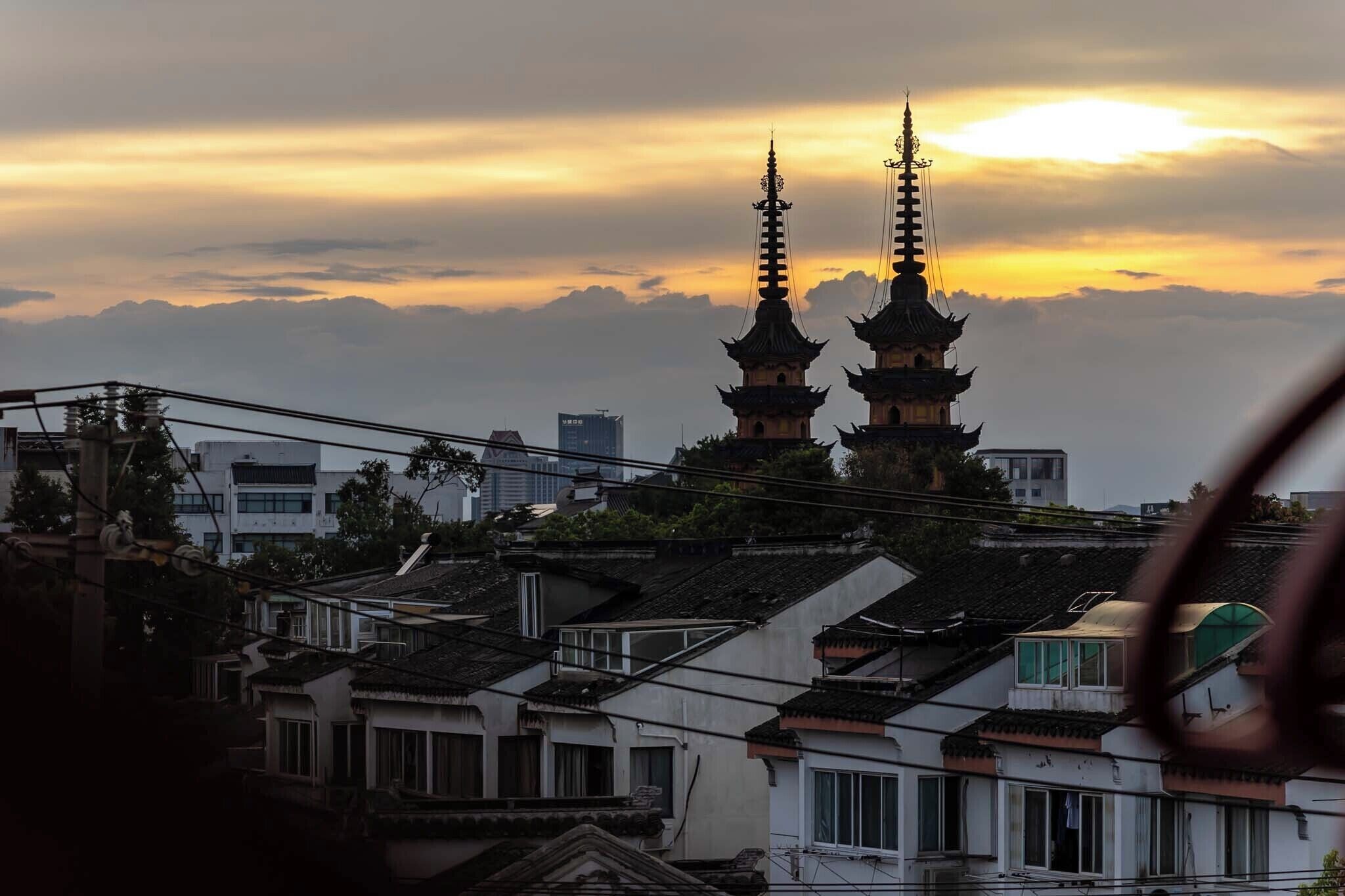 A traditional pagoda with multiple tiers, surrounded by residential buildings.