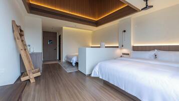 A modern hotel room with a wooden ceiling, a large bed, a desk, and a small bathroom.