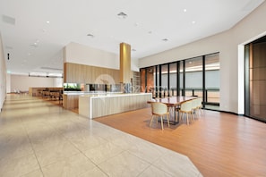 A spacious, modern hotel lobby with a central island, seating area, and large windows. - Avior by Kozystay - Kemayoran (Central Jakarta)