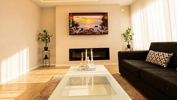A modern living room with a fireplace, a sofa, and a coffee table. - Seavista Trelleborg Sea View & Jacuzzi (Trelleborg)