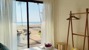 A bedroom with a bed, a view of the beach, a ceiling fan, and a wooden ladder. - Beachfront House with Private Pool, near Troncones (Gro.)