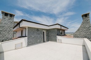 A modern building with stone walls and a flat roof terrace. - Daulia, apartment in a villa near Soverato, on the Ionian coast of Calabria — open year-round (Marina di Davoli)